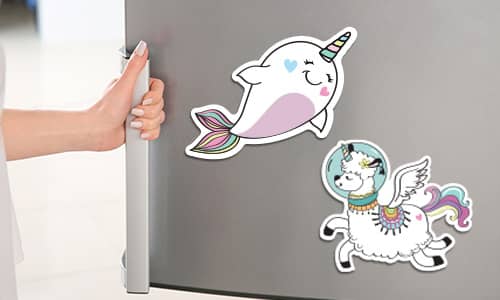 Fridge Magnets on a fridge door with a hand opening the door. 